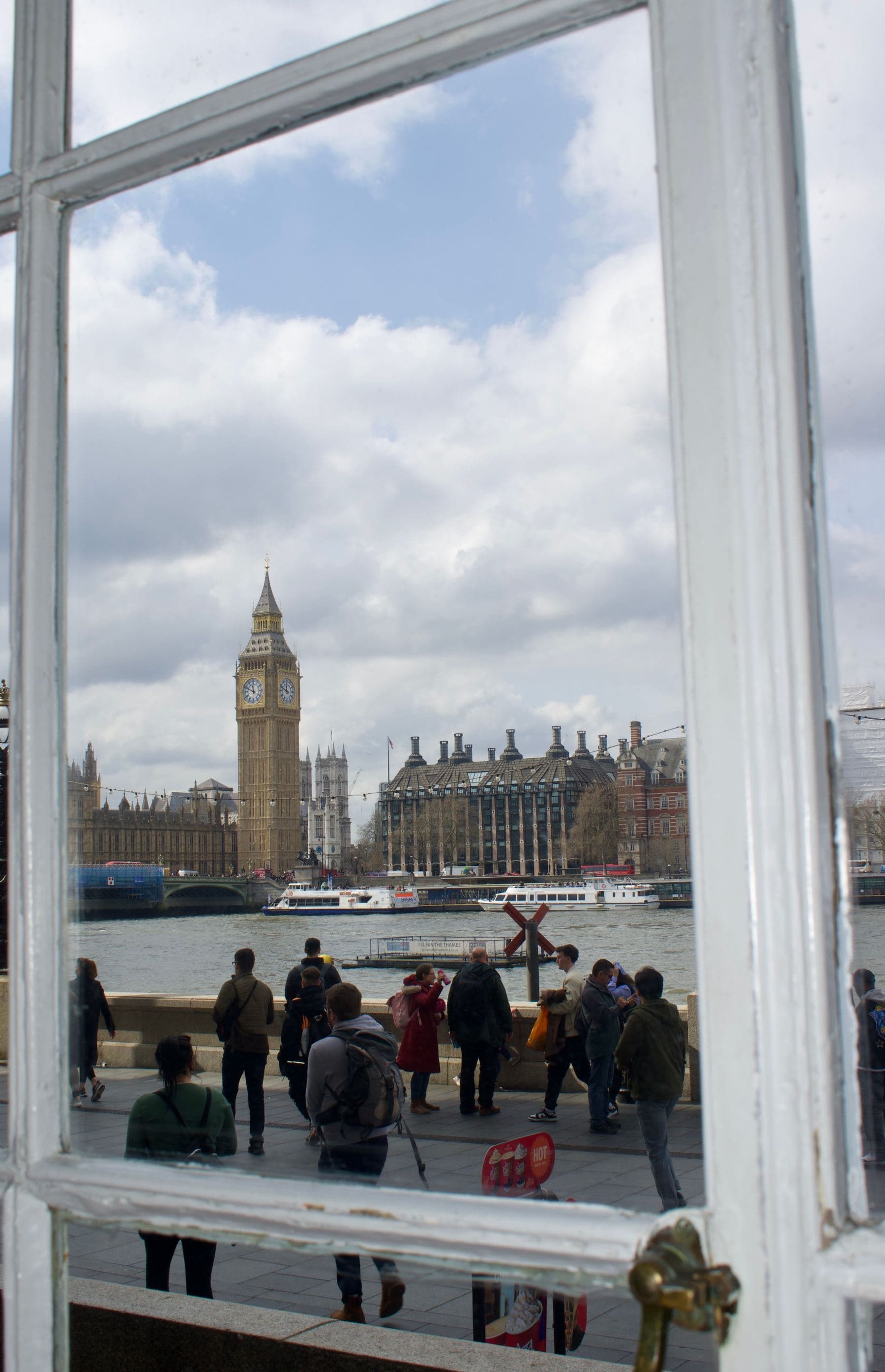 A window looking out across the Thames to Big Ben and the Houses of Parliament.